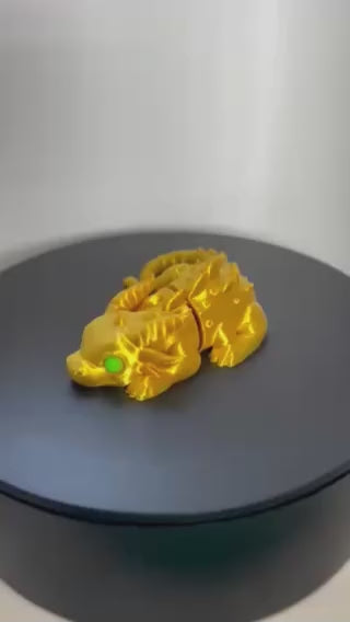 Gold Dragon Fidget with green eyes